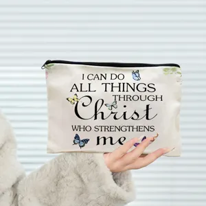 Canvas makeup pouch detail shot, featuring inspirational text print and secure zipper closure.