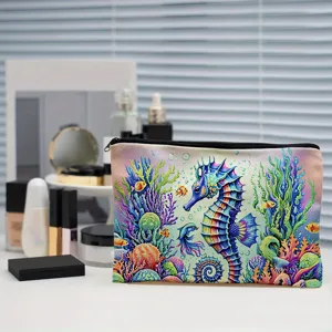 Close-up detail of colorful canvas makeup pouch featuring vibrant seahorse coral print design.