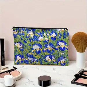 Detailed view of blue floral makeup pouch, canvas zipper cosmetic bag on marble surface.