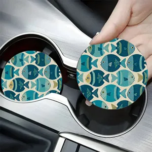 Close-up detail shot of cute blue fish pattern car cup coasters placed in vehicle holder.