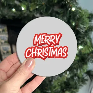 Close up detail of a festive round car cup coaster featuring bold Merry Christmas text.