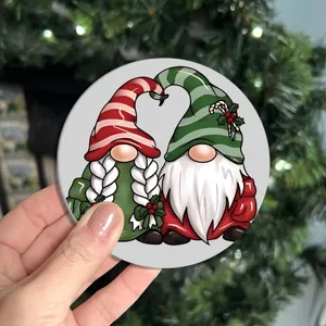 Detail shot of a cute Christmas gnome couple ceramic coaster for holiday home decor.