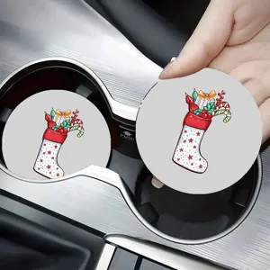 Detailed view of Christmas stocking print car coasters placed inside the vehicle cup holder.