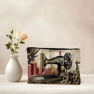 Closeup of the canvas cosmetic bag featuring a charming vintage sewing machine art print.