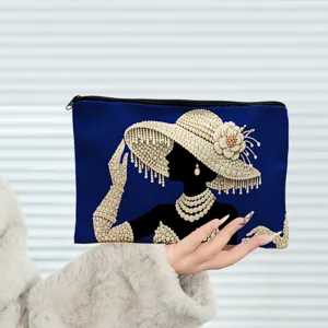 Detailed close-up view of the elegant canvas cosmetic bag with pearl lady graphic pattern.