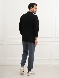 Detailed view of men's black long sleeve polo shirt, comfortable casual wear for daily use.