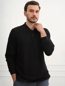 Close-up detail view of the black long sleeve polo shirt showing collar and button design.