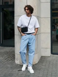 Men's light blue casual denim jeans paired with white t-shirt for daily streetwear fashion.