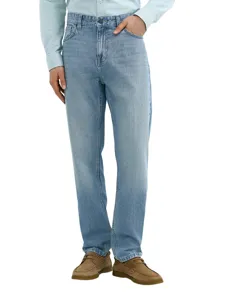 Detailed view of men's light blue loose straight jeans worn by model, casual style clothing.