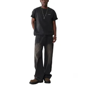 Detailed view of dark gray washed loose straight jeans and matching tee, distressed finish.