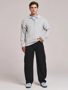 Close-up detail showcasing the soft knit texture and half-zip collar design of the apparel.