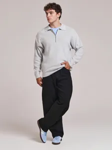 Men's loose straight-leg denim jeans detail shot, comfortable casual black trousers design.