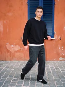 Felpa oversize nera in felpa per uomo con dettaglio di orlo bianco sovrapposto.