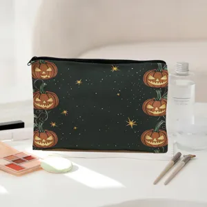 Halloween pumpkin print makeup bag detail view showing dark zipper pouch design style.