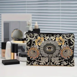 Trousse de maquillage en toile avec imprimé de tournesol et yeux pour le rangement.