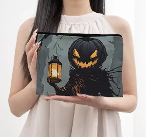 Close-up detail of the Halloween pumpkin monster canvas cosmetic storage bag handheld.