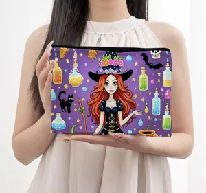 Close-up detail view of the cartoon witch print cosmetic pouch, showing vibrant colors and zipper.