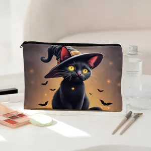 Detailed shot of Halloween black cat witch hat print zipper makeup bag on white desk.