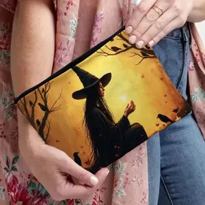 Detailed view of the witch and raven print cosmetic makeup bag with black zipper closure.