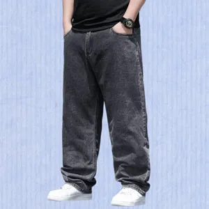 Casual loose fit denim trousers detail shot, showing vintage washed black texture and wide leg style.