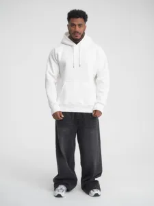 Close-up view of the solid white hooded sweatshirt worn by a model, featuring drawstrings.
