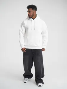 Close-up of thick white hooded sweatshirt featuring drawstring and front pocket detail.