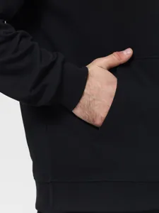 Close-up detail of mens black fleece hoodie pocket and ribbed cuff casual winter apparel
