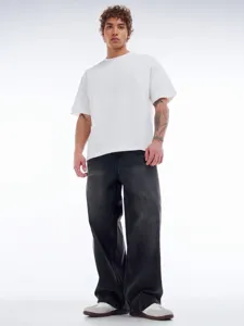 Vue détaillée du jean droit délavé coupe loose pour homme porté par le modèle, style.