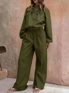 Detailed view showcasing the stylish olive green casual jacket and matching wide-leg trousers.