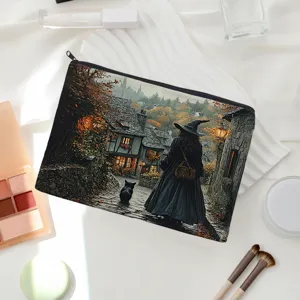 Detailed view of linen makeup pouch featuring vintage fantasy witch and black cat illustration.