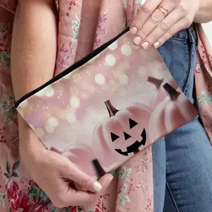 Pink pumpkin print cosmetic bag for travel and daily makeup storage, durable zipper closure.