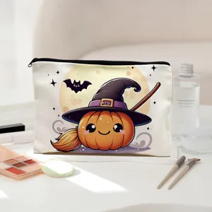 Close-up detail of the cute Halloween pumpkin witch print canvas zipper makeup bag on white table.