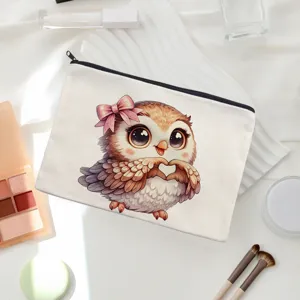 Cute cartoon owl canvas cosmetic bag detail, featuring pink bow and heart wings design.