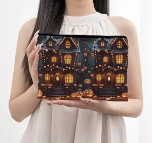 Halloween canvas cosmetic bag with spooky haunted house and pumpkin print for daily storage.