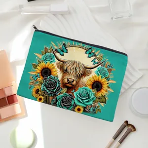 Teal canvas cosmetic pouch with Highland cow and floral print for daily makeup organization.