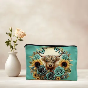 Turquoise makeup bag detail showing highland cow print, sunflowers and sturdy zipper bag.