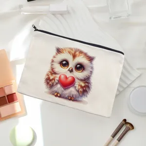 Close-up detail of the linen makeup bag featuring cute owl pattern and smooth black zipper closure.
