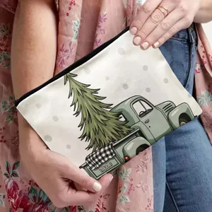 Canvas makeup pouch featuring a vintage green truck and Christmas tree design with zipper closure.