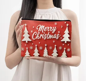 Close-up detail view of a festive red Christmas cosmetic pouch with cute trees pattern.