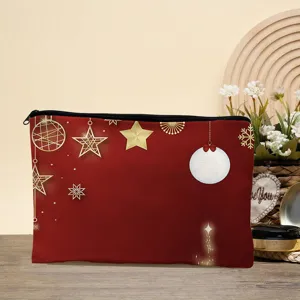 Close-up detail of the red cosmetic pouch featuring elegant gold Christmas stars and snowflake print.