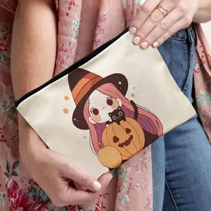 Detailed view of canvas cosmetic bag featuring cute Halloween witch and pumpkin illustration.