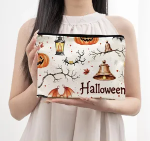 Detail view of autumn Halloween canvas makeup bag with festive watercolor pumpkin prints.