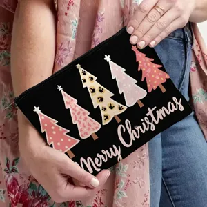 Close-up detail of the black cosmetic pouch featuring festive Christmas tree patterns and text.