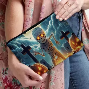 Halloween canvas cosmetic pouch featuring a spooky mummy and pumpkin graveyard print design.