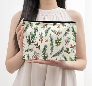 Detail view of the Christmas pine and berry cosmetic pouch featuring a smooth black zipper.