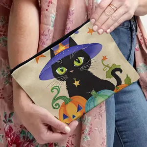 Close-up of canvas cosmetic pouch featuring a cute black cat and pumpkin autumn holiday print.