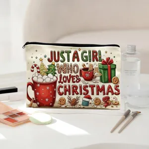 Detail view of a Christmas themed canvas makeup bag with festive print and black zipper.