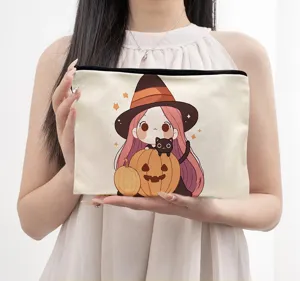Canvas cosmetic pouch detail view, cute Halloween witch and pumpkin anime print design.