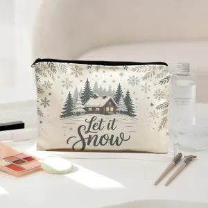 Close-up detail of the canvas cosmetic pouch featuring winter snow cabin print and zipper closure.