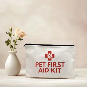White canvas pet first aid kit bag detail view with red cross and paw print motif